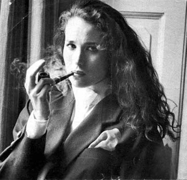 Andi McDowell smoking a pipe
