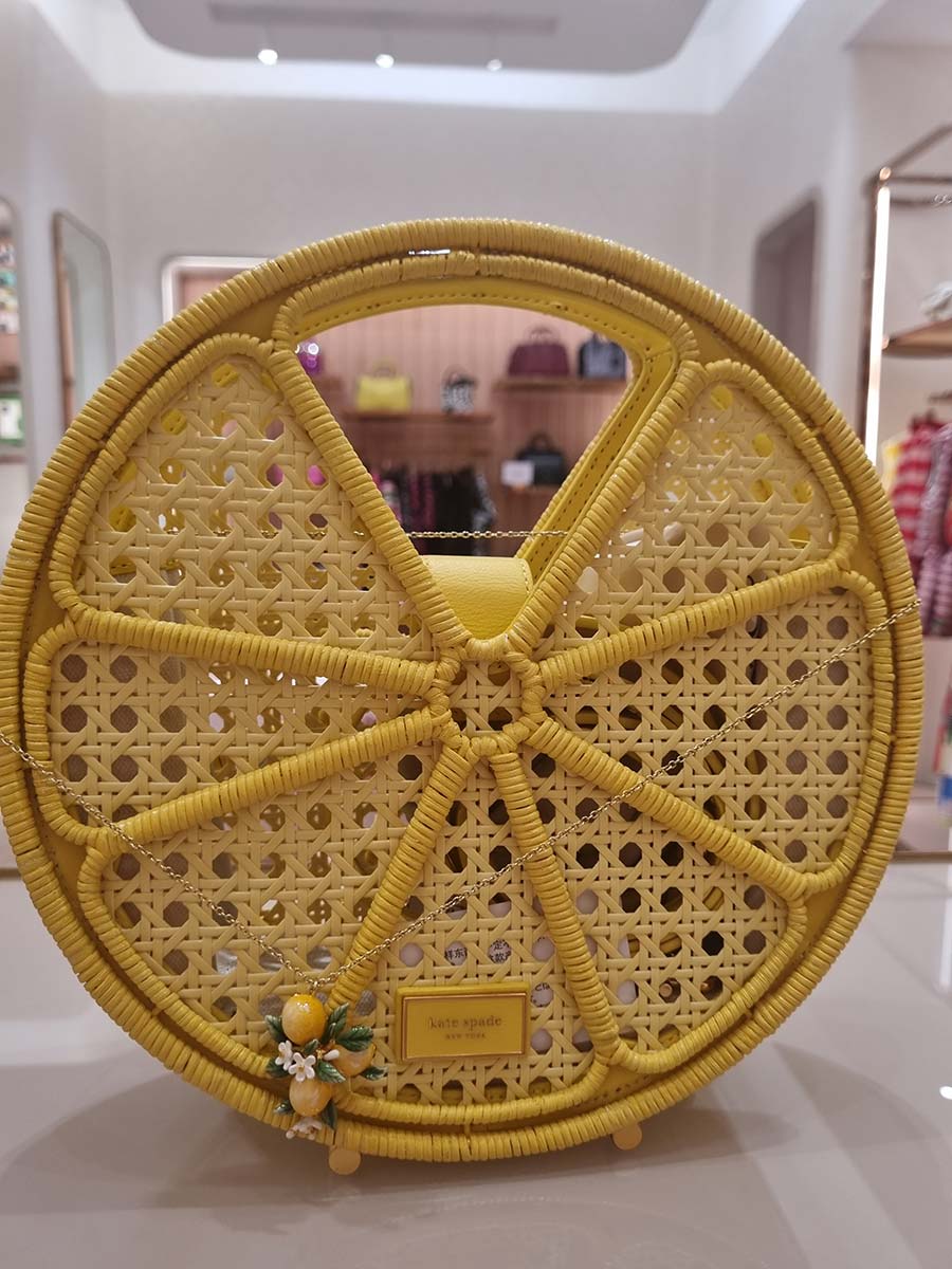 Gracie Opulanza wearing kate Spade Wicker Tote bag