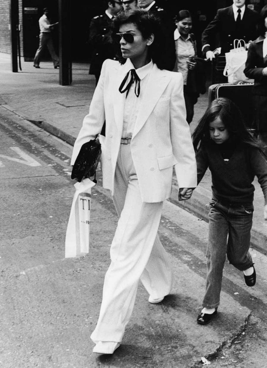 He Provided Women With Identical Garments To Men Women had already been wearing suits and trousers before Saint Laurent's contribution, however, it was Pierre Berg who stated in 2008 that Gabrielle Chanel granted women freedom, while Yves Saint Laurent bestowed upon them power. The introduction of Le Smoking in 1966 was met with controversy, as it was still considered taboo for women to wear trousers in public. Nan Kempner, an American socialite, famously faced rejection at Le Cte Basque in New York for donning her YSL tuxedo suit. At its core, Le Smoking represents rebellion, androgyny, and glamour - a direct challenge to the established norms. Saint Laurent expressed in 1977 that he aimed to provide women with the same fundamental wardrobe as men, consisting of a blazer, trousers, and suit, emphasizing their functionality. His belief that women desired this type of attire turned out to be correct. Notable early adopters of Le Smoking included Catherine Deneuve, Liza Minnelli, Lauren Bacall, and Bianca Jagger.